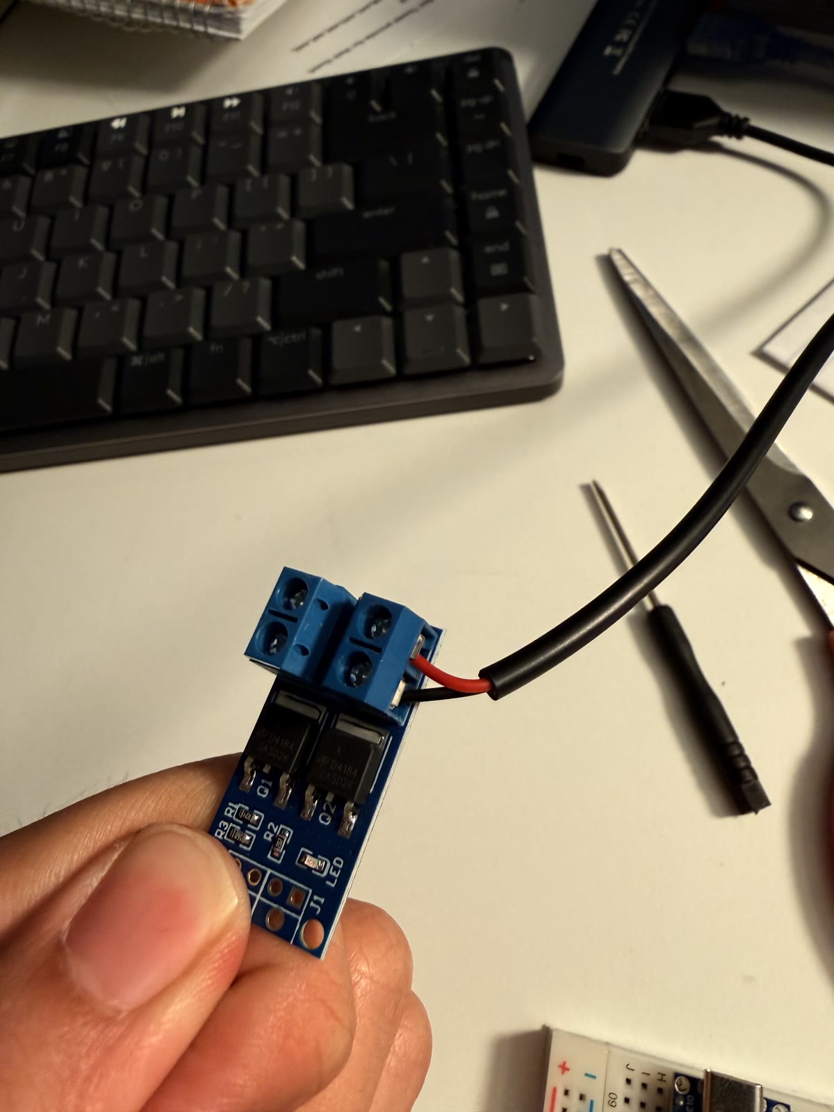 MOSFET driver module with red and black power wires attached